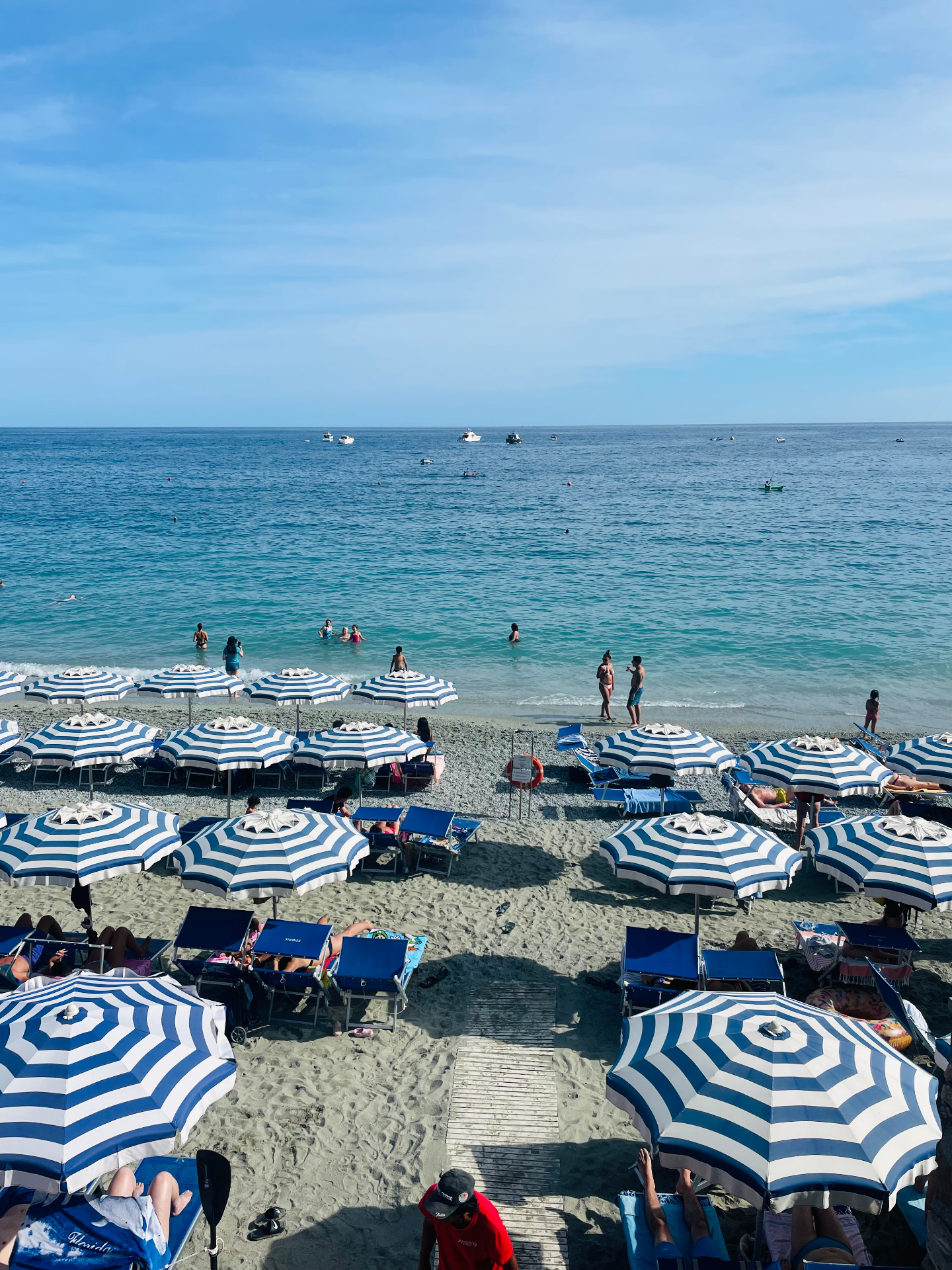 Striped umbrellas and turquoise water on an Italian beach